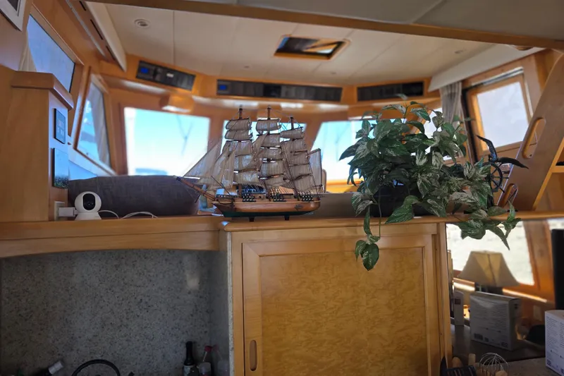 Slide: The Image of Interior of 2000 McKinna 48 Pilothouse with model ship and plant decor. - 22