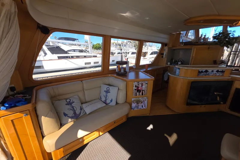 Slide: The Image of Luxurious interior of 2000 McKinna 48 Pilothouse yacht with cozy seating and nautical decor. - 23