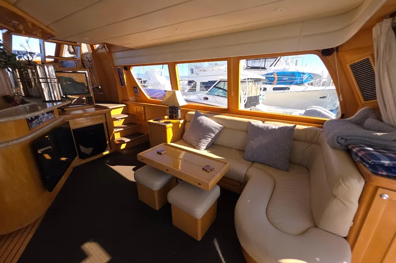 Slide: The Image of Luxurious interior of 2000 McKinna 48 Pilothouse yacht with cozy seating and elegant decor. - 24