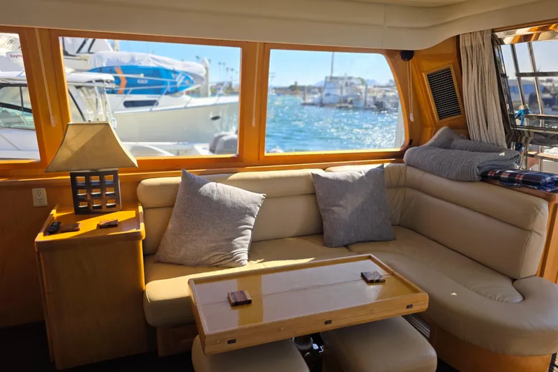 Slide: The Image of Interior of 2000 McKinna 48 Pilothouse yacht with cozy seating and ocean view. - 27