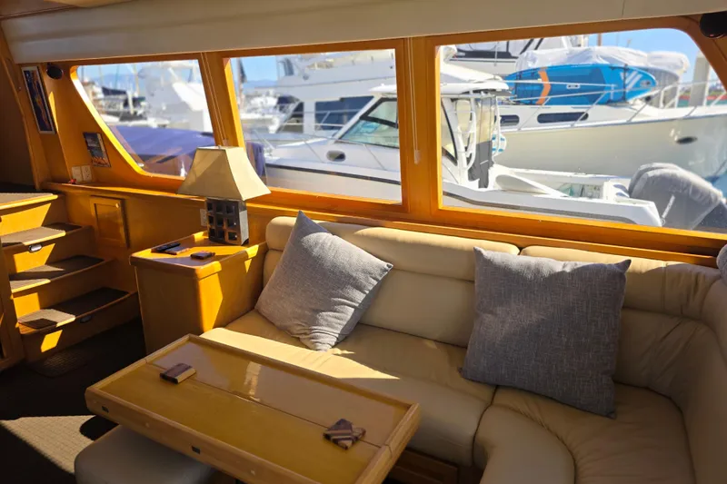 Slide: The Image of Luxurious interior of 2000 McKinna 48 Pilothouse yacht with comfortable seating and large windows. - 28