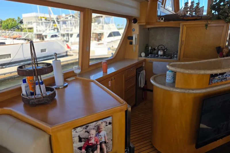 Slide: The Image of Interior of 2000 McKinna 48 Pilothouse yacht with kitchen and marina view. - 32
