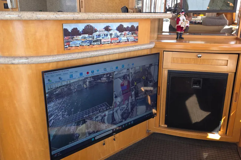 Slide: The Image of Interior of 2000 McKinna 48 Pilothouse with security monitor and wooden cabinetry. - 34