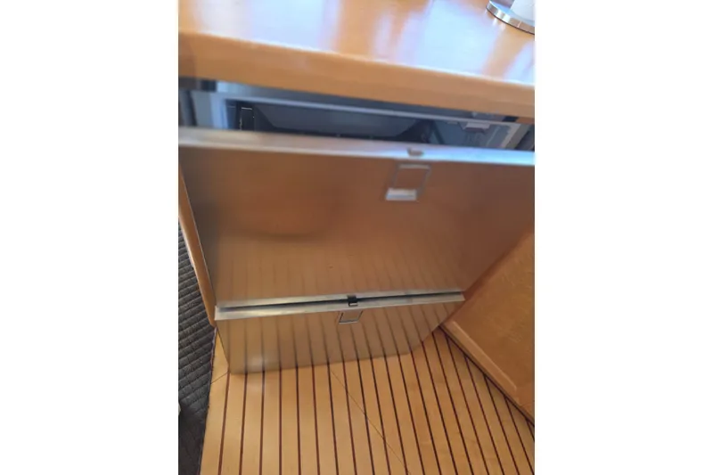 Slide: The Image of Open drawer in McKinna 48 Pilothouse yacht, showcasing wooden interior, 2000 model. - 36