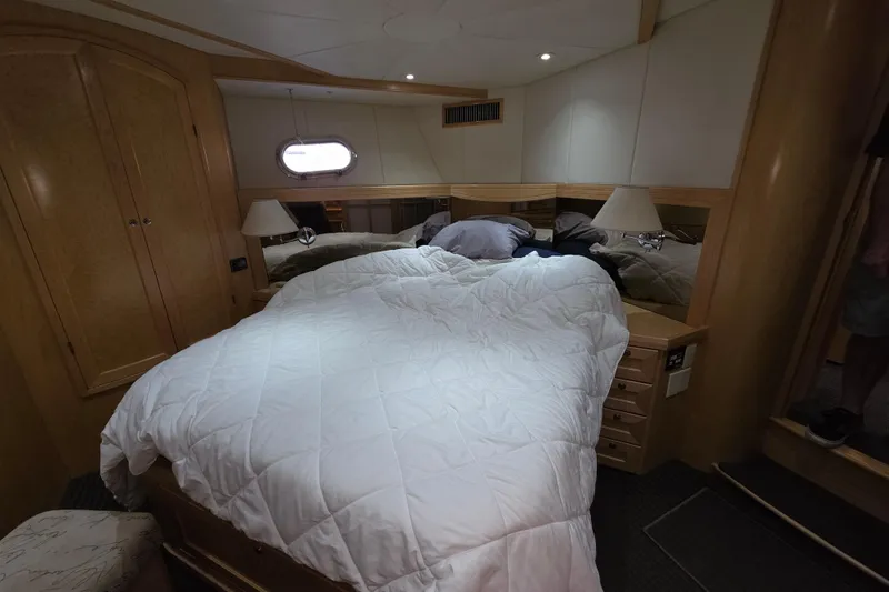 Slide: The Image of Luxurious bedroom interior of 2000 McKinna 48 Pilothouse yacht with cozy bedding. - 39