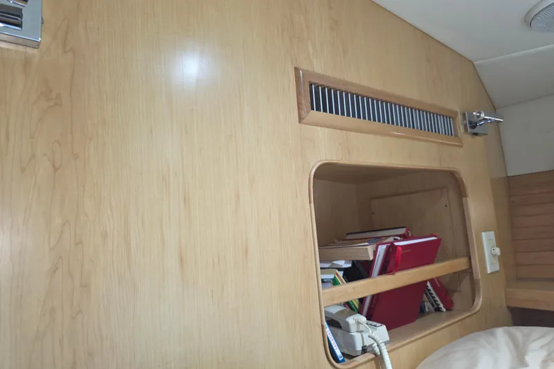 Slide: The Image of Interior of 2000 McKinna 48 Pilothouse with wooden paneling and storage shelf. - 42