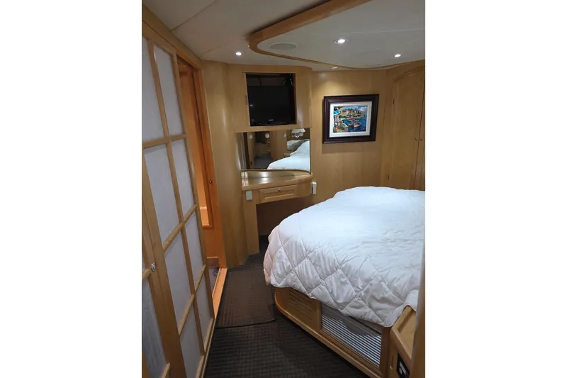 Slide: The Image of Luxurious cabin interior of 2000 McKinna 48 Pilothouse yacht with cozy bed and elegant decor. - 48