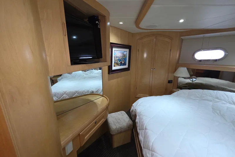 Slide: The Image of Luxurious cabin interior of 2000 McKinna 48 Pilothouse yacht with cozy bed and TV. - 51