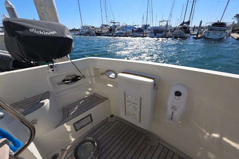 Slide: The Image of Cockpit of 2000 McKinna 48 Pilothouse yacht with marina view and sunny weather. - 57
