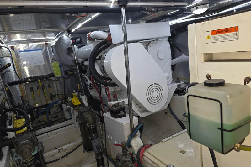 Slide: The Image of Engine room of 2000 McKinna 48 Pilothouse yacht, showcasing mechanical components and systems. - 64