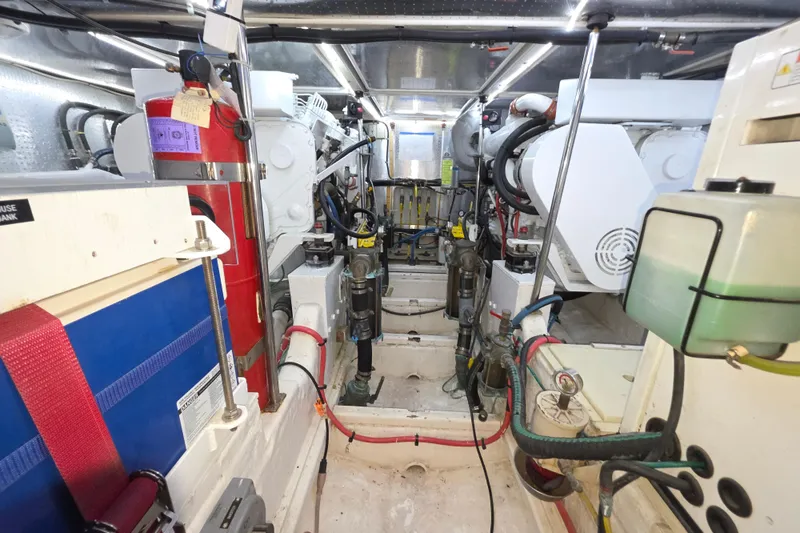 Slide: The Image of Engine room of 2000 McKinna 48 Pilothouse yacht, showcasing mechanical components and systems. - 66