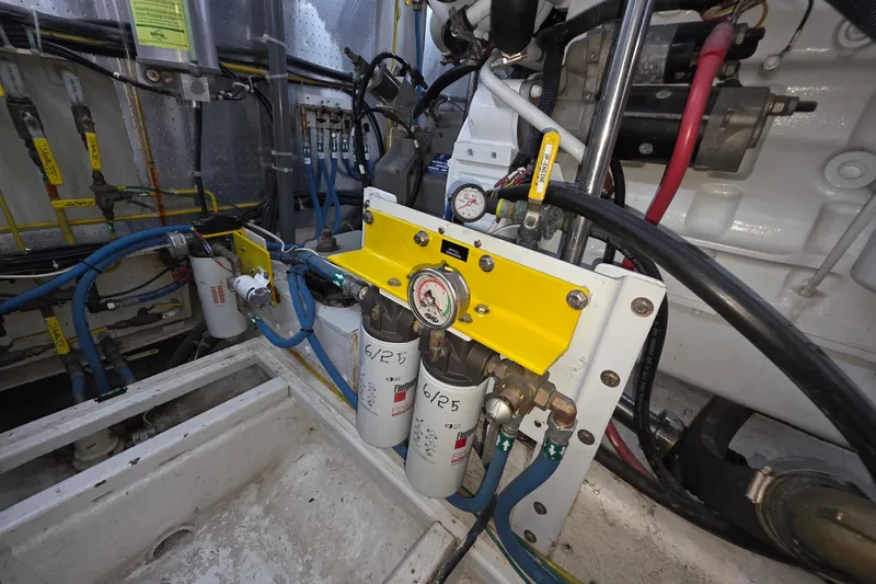 Slide: The Image of Engine room of 2000 McKinna 48 Pilothouse with fuel filtration system and gauges. - 68