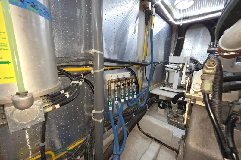 Slide: The Image of Engine room of 2000 McKinna 48 Pilothouse with visible pipes and machinery. - 70