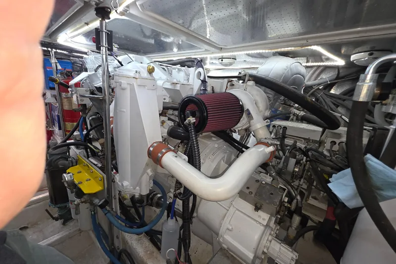 Slide: The Image of Engine room of a 2000 McKinna 48 Pilothouse yacht, showcasing mechanical components. - 71