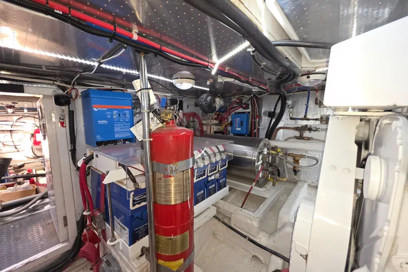 Slide: The Image of Engine room of 2000 McKinna 48 Pilothouse with fire extinguisher and electrical equipment. - 72