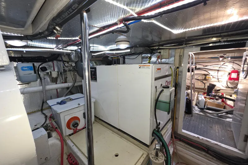 Slide: The Image of Engine room of 2000 McKinna 48 Pilothouse yacht, featuring equipment and storage. - 73
