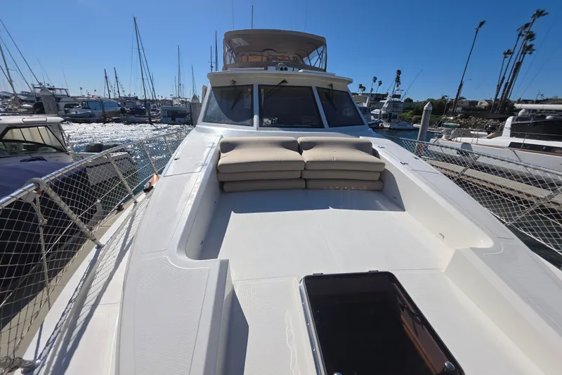 Slide: The Image of 2000 McKinna 48 Pilothouse yacht docked at marina, sunny day, clear sky. - 77
