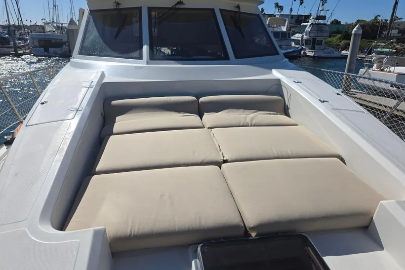 Slide: The Image of Luxurious sunbathing area on a 2000 McKinna 48 Pilothouse yacht in a marina. - 78