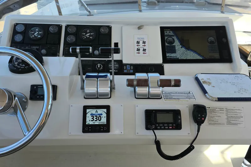 Slide: The Image of Pilothouse dashboard of 2000 McKinna 48, featuring navigation instruments and controls. - 8
