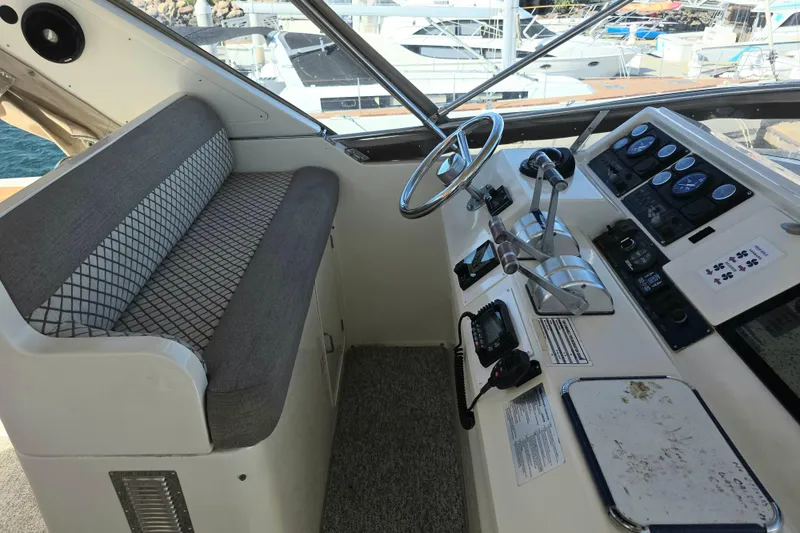 Slide: The Image of Pilothouse interior of 2000 McKinna 48, featuring steering wheel and control panel. - 9