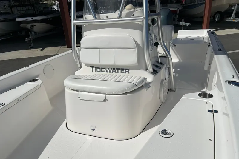 Slide: The Image of 2014 Tidewater 2100 Bay Max boat interior with white seating and console. - 10