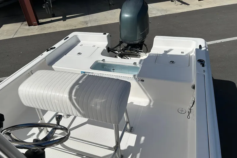 Slide: The Image of 2014 Tidewater 2100 Bay Max boat interior with seating and motor. - 12