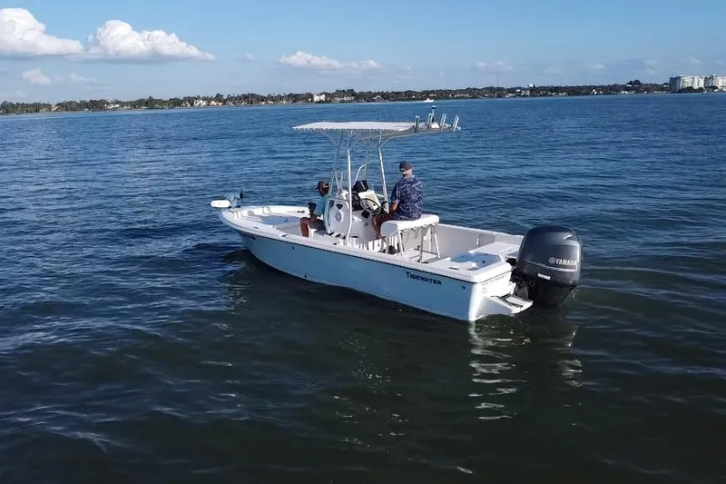 Slide: The Image of 2014 Tidewater 2100 Bay Max boat on calm water with two people onboard. - 19