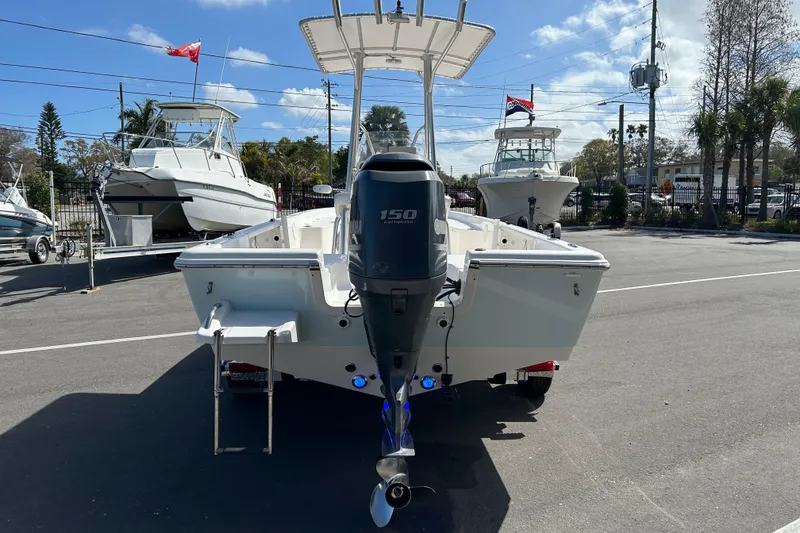 Slide: The Image of 2014 Tidewater 2100 Bay Max boat with 150 HP engine, parked outdoors. - 3