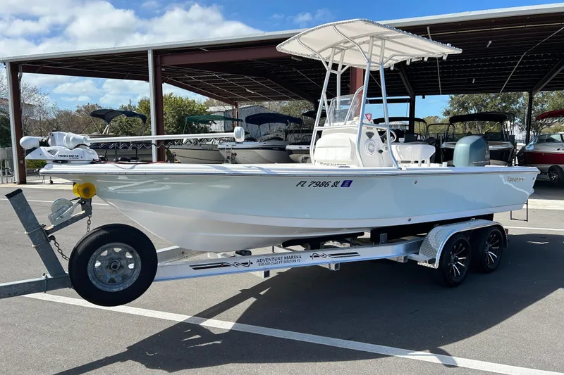 Slide: The Image of 2014 Tidewater 2100 Bay Max boat on trailer, parked outdoors under a canopy. - 5