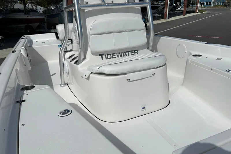 Slide: The Image of 2014 Tidewater 2100 Bay Max boat interior with white seating and console. - 9