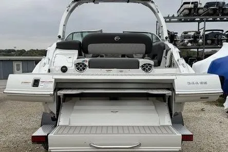 The Image of 2026 Crownline 288 SS boat rear view with open storage compartment and speakers. - 1