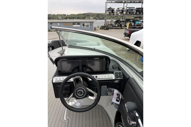 Slide: The Image of 2026 Crownline 288 SS boat dashboard with steering wheel and control panel. - 13