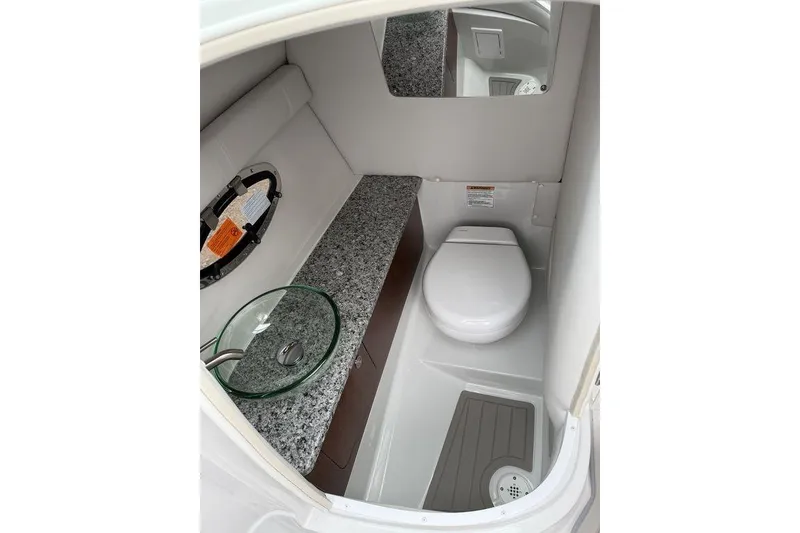 Slide: The Image of 2026 Crownline 288 SS boat bathroom with granite countertop and modern fixtures. - 14