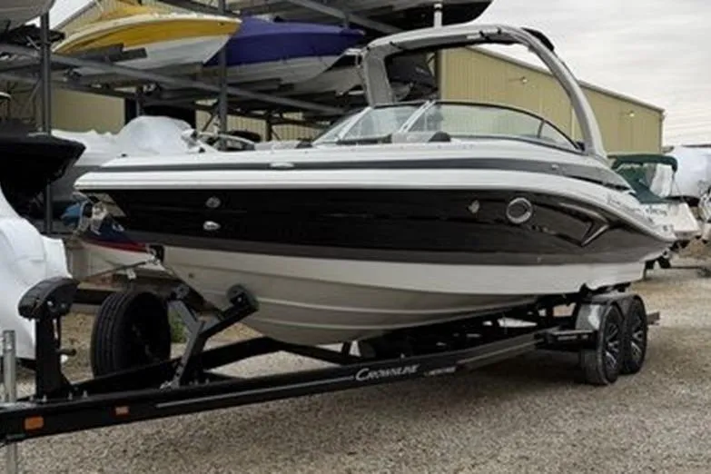 Slide: The Image of 2026 Crownline 288 SS boat on trailer in storage facility. - 3