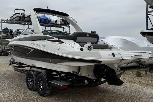 Slide: The Image of 2026 Crownline 288 SS boat on trailer, sleek design, dual axle, outdoor storage. - 4
