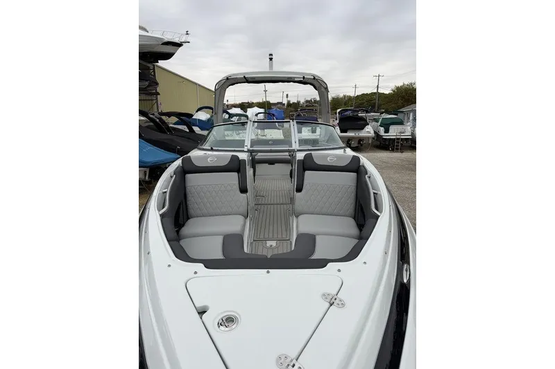 Slide: The Image of 2026 Crownline 288 SS boat with sleek seating and modern design in a marina setting. - 7