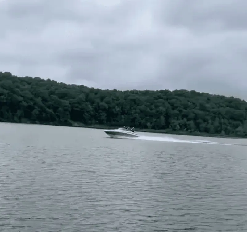 Slide: The Image of 2010 Sea Ray 220 boat cruising on a calm lake. - 1