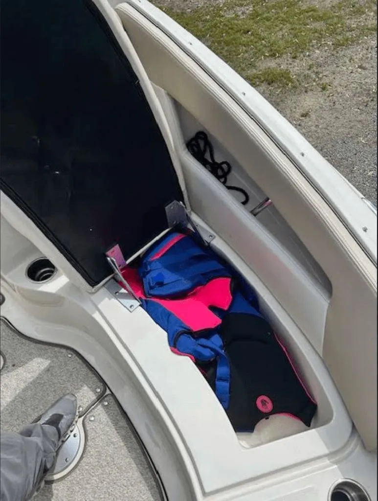 Slide: The Image of Storage compartment of a Sea Ray 220 boat with life jackets. - 11
