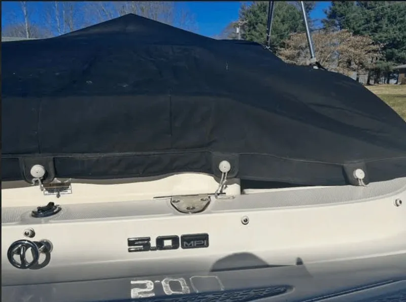 Slide: The Image of 2010 Sea Ray 220 boat with black cover, 5.0 MPI engine. - 14