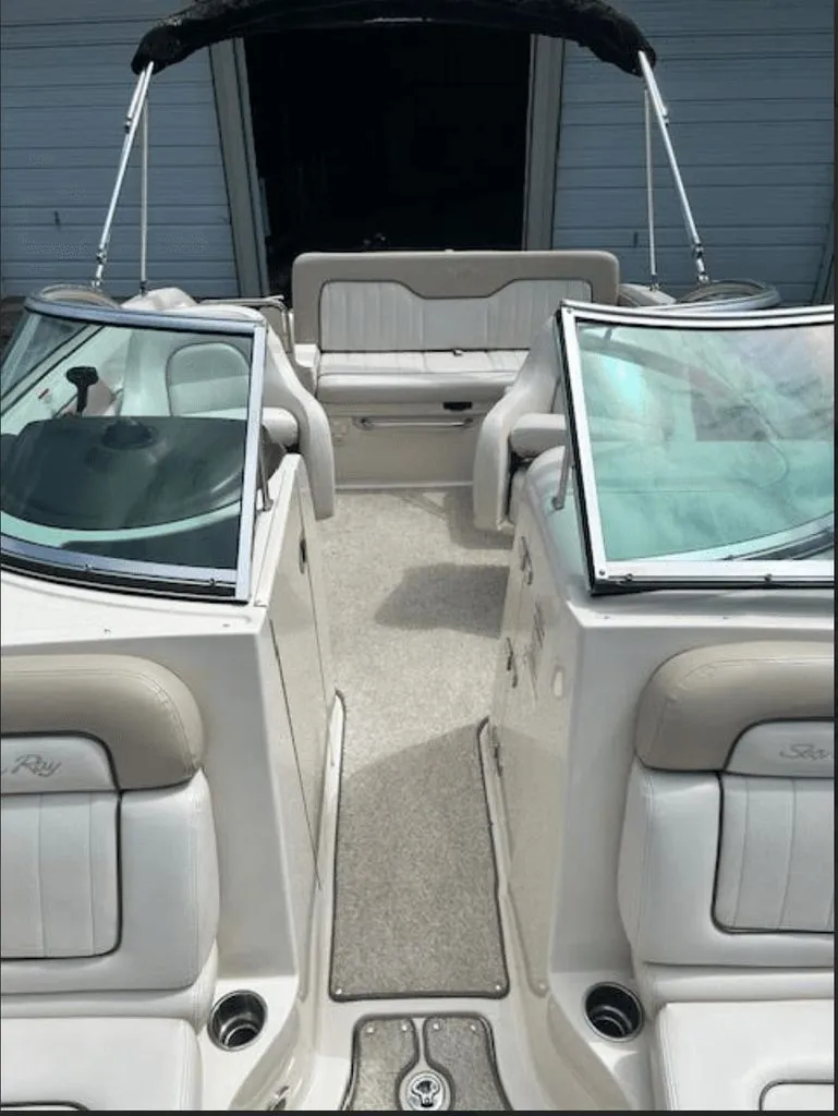 Slide: The Image of 2010 Sea Ray 220 boat interior with seating and windshield. - 2
