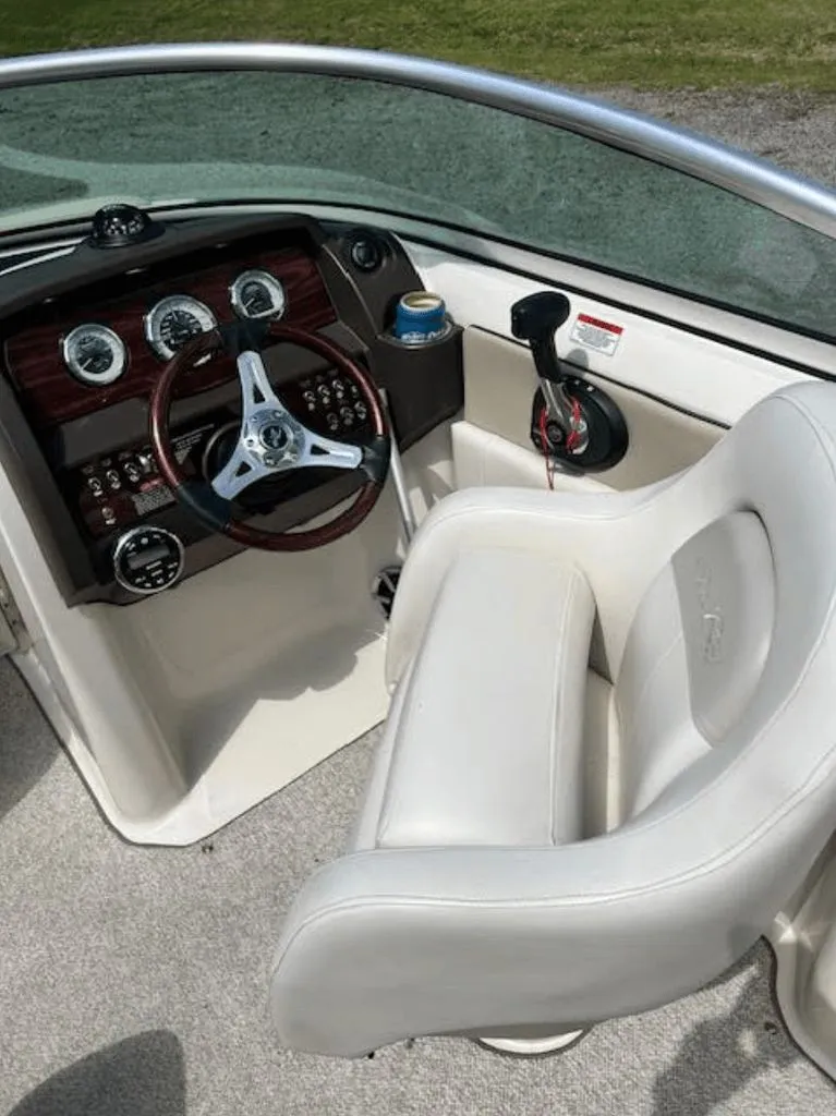 Slide: The Image of Interior of a 2010 Sea Ray 220 boat with steering console. - 4