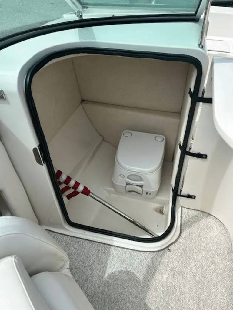 Slide: The Image of 2010 Sea Ray 220 boat interior with portable toilet. - 8
