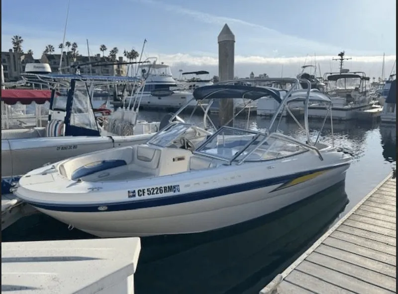 The Image of 2004 Bayliner DECK BOAT 219SD docked at marina. - 0