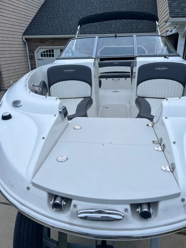 Slide: The Image of 2018 Stingray 235 LR boat with open deck and seating. - 10