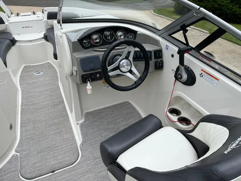 Slide: The Image of Interior view of 2018 Stingray 235 LR boat with steering console. - 2