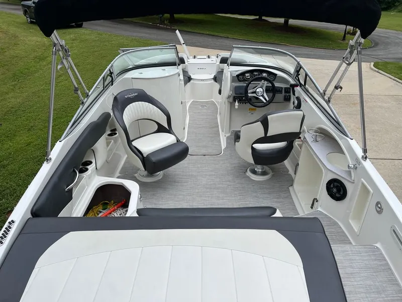 Slide: The Image of Interior of a 2018 Stingray 235 LR boat with seating and helm. - 3