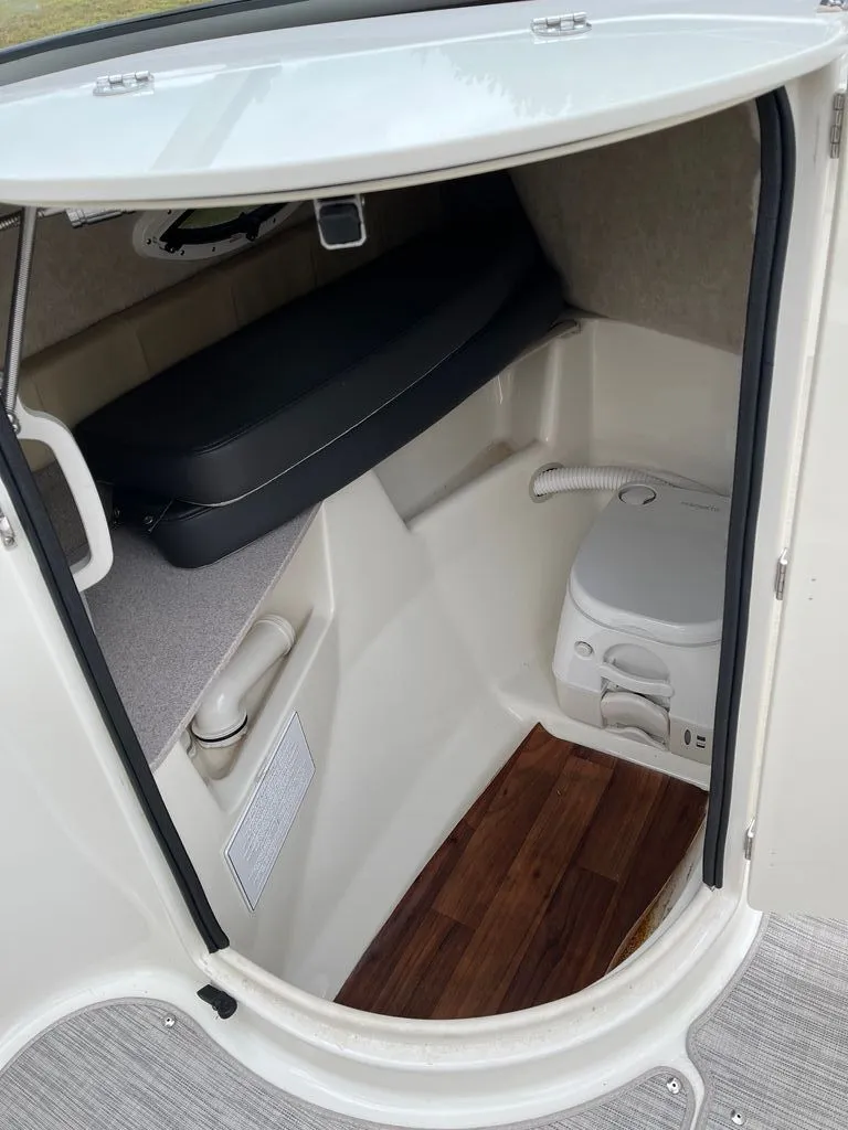 Slide: The Image of Interior of 2018 Stingray 235 LR with toilet and seating area. - 8