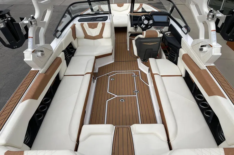 Slide: The Image of 2021 Nautique Super Air Nautique G25 interior with luxurious seating and sleek design. - 5