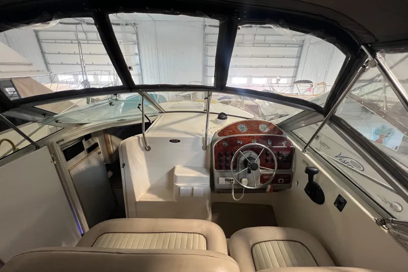 Slide: The Image of 1997 Maxum 2800 SCR boat interior with steering wheel and dashboard controls. - 10