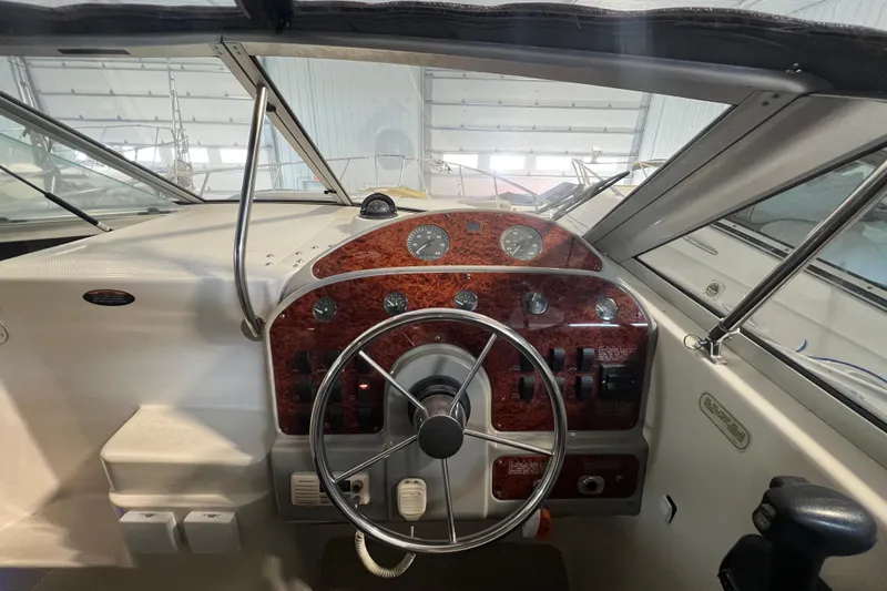 Slide: The Image of 1997 Maxum 2800 SCR boat dashboard with steering wheel and instrument panel. - 11
